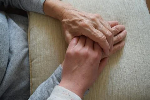 Hands of people of different generations hold each other Stock Photos