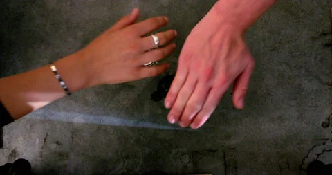 Hands of people picking tot glasses with flammable whisky from the table Video stock 238780635
