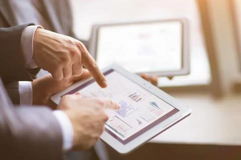 Hands of people working with tablet computer in office. Technology. Stock Photos