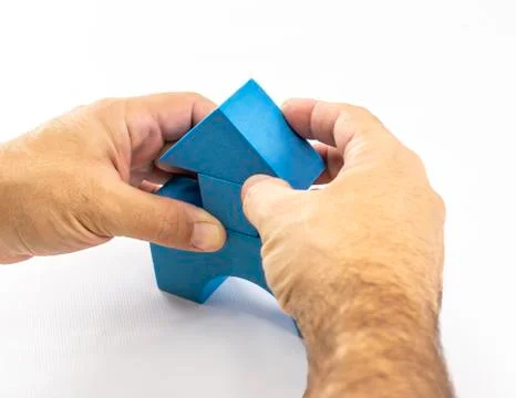Hands perform a construction with constructive elements of a children's toy Stock Photos
