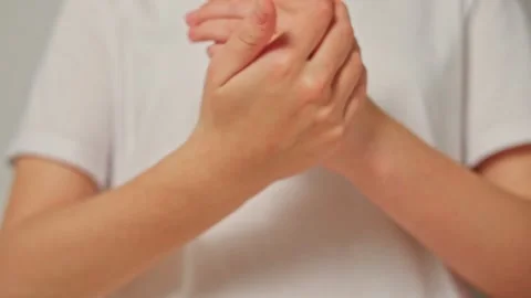 Hands performing gentle stretching exercises for relaxation and pain relief at Stock Footage 311952456