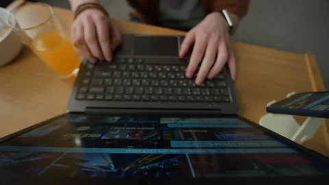 Hands of Person Browsing Digital Video Game Store on Laptop Computer Stock Footage 340814659