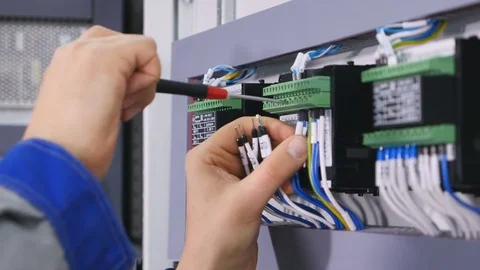 Hands of person making a maintenance of the wires with the screw gun. 4K Vídeo Stock 73596830