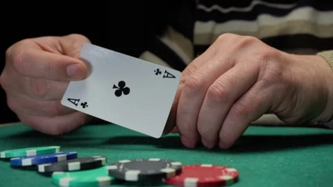 Hands of a person shuffling a deck of playing cards while placing poker chips on Stock Footage 333786061