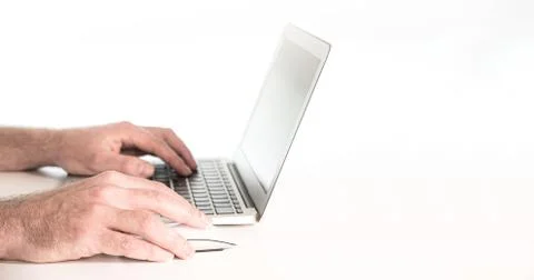 Hands of person using laptop computer against white background Stock Photos