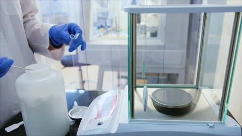 Hands of a pharmacist in a white coat take the substance Stock Footage 103703156