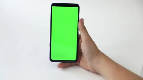 In the hands of a phone with a green screen on a light background Stock Footage 222814458