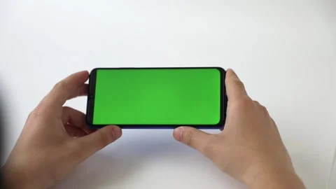 In the hands of a phone with a green screen on a light background Stock-Footage 232021206