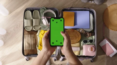 Hands phone green screen packed suitcase. Moving to apartment house emigration Stock Footage 252530150