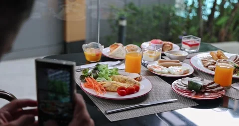 Hands photographing lavish breakfast buffet - Hotel dining concept Stock Footage 327689052