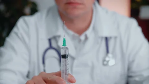 The hands of a physician are preparing a syringe with medicine for intravenous Stock Footage 154253594