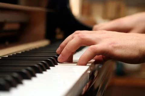 Hands of a piano playing guy in a sensitive mood Stock Photos