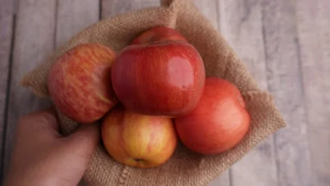 Hands pick up and puts down bowl of apples on the table 库存影片 275872397