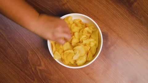 Hands to pick up eating potato chips Stock Footage 262261590