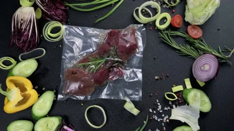 Hands pick up fresh, beautifully laid out meat in a vacuum package, decorated Stock-Footage 131016053