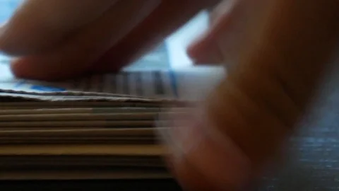 Hands picking up newspapers from a pile Stock Footage 115991159