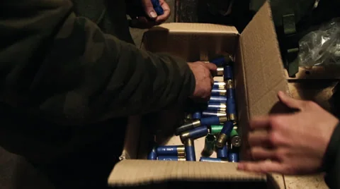 Hands Picking Shotgun Shells From Cardboard Box 動画素材 33790096