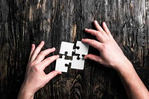Hands with pieces of jigsaw Stock Photos