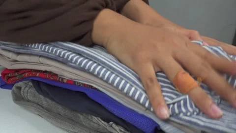 Hands pile up neat clothes 库存影片 276399470