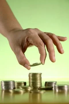 Hands Piling Coins Stock Photos
