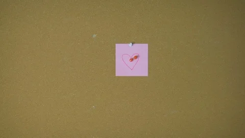 Hands pining heart on sticky notes on pin board funny animation Stock Footage 98847712