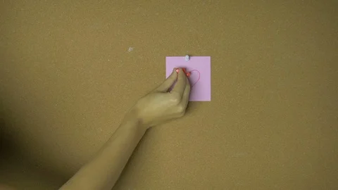 Hands pining heart on sticky notes on pin board funny animation Stock Footage 98848015