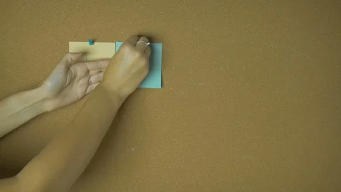 Like Hands pining sticky notes on pin board funny animation Stock Footage 99609574