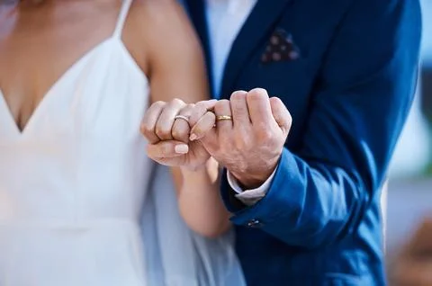 Hands, pinky promise and wedding ring of couple outdoor celebration of trust Stock Photos