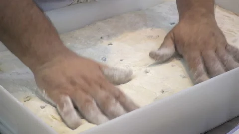 Hands place dough in a baking dish in 4K Stock Footage 147652018