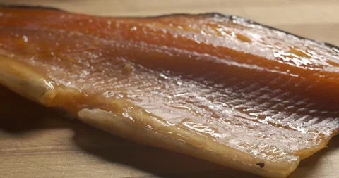Hands place the dried red fish fillet on a cutting board Stock Footage 312145186