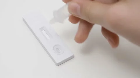 Hands place sample into the covid-19 antigen diagnostic test device. Teenage boy Stock Footage 170124266