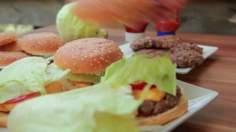 Hands placed on top of the hamburger buns Stock Footage 67379797
