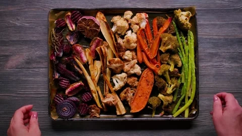 Hands Placing Baking Tray with Roasted Vegetables Top View Stock-Footage 334338220