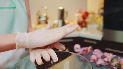 Hands placing banana candy pieces in kitchen mixing bowl Vídeo Stock 342877580