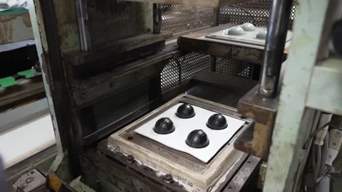Hands Placing Black Rubber Hemispheres Onto Mold Plate at Ball Plant Vídeo Stock 339736622