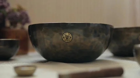 Hands Placing a Decorated Tibetan Singing Bowl Stock Footage 335329380
