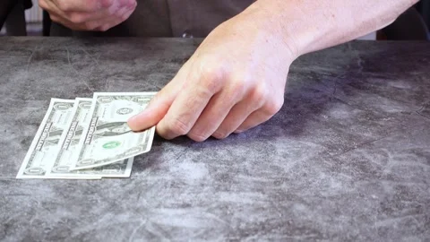 Hands placing dollar bills Stock Footage 278922236