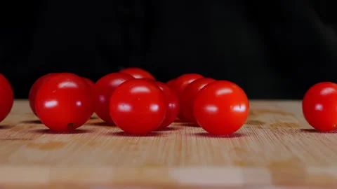 Hands Placing Fresh Cherry Tomatoes on Cutting Board. Video stock 346861704