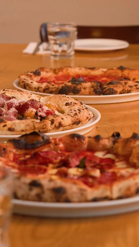 Hands Placing Fresh Neapolitan Pizza on a Restaurant Table 스톡 동영상 338055011
