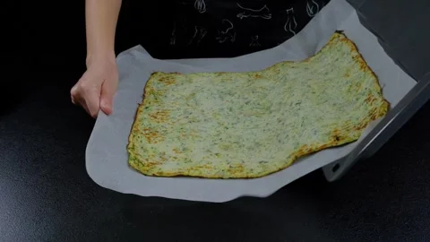 Hands Placing Green Speckled Flatbread on Baking Sheet Cooking Stock Footage 341422176