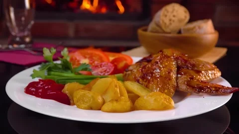 Hands placing a plate with baked chicken wings Stock Footage 293129154
