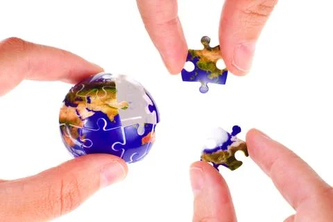 Hands Placing Puzzle Pieces into Globe on White Background Stockfoto's