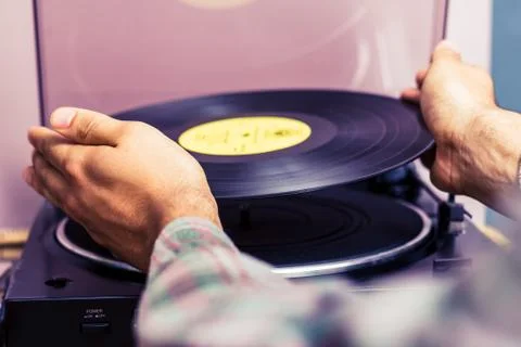 Hands placing record on turntable Stock-Fotos