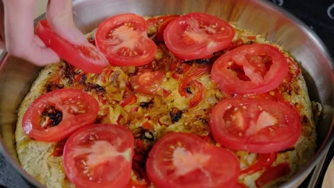 Hands Placing Tomato Slices on Omelet in Cooking Kitchen Video stock 341433877