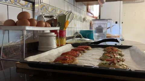 Hands placing Valencian coca tray on kitchen counter Stock Footage 342822172