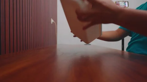 Hands Placing White Container on Wooden Table Indoors 動画素材 333320722