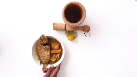Hands placing white rice dish with onion sauce and fried fish Stock Footage 199146359