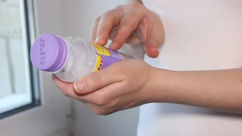 Hands plastic bottle reading lettering Stock Footage 105621088
