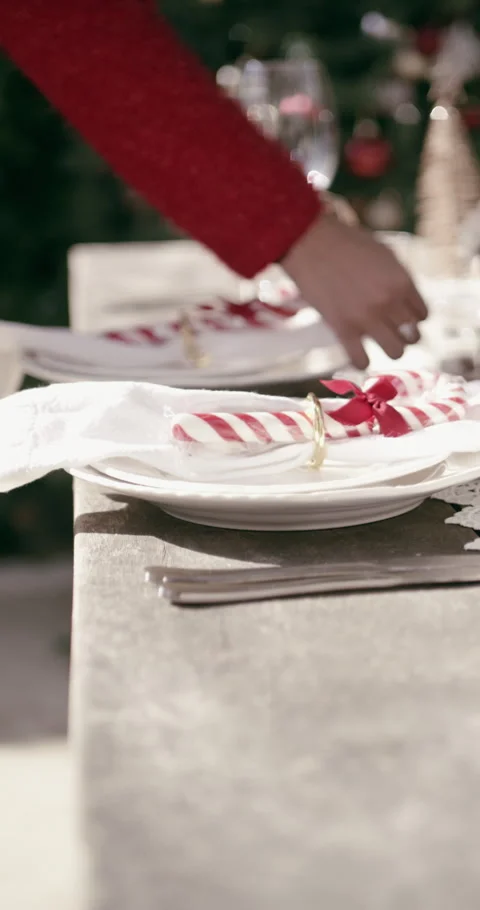Hands, plates and setting table at Christmas for lunch, candy cane or outdoor Stock Footage 329747286