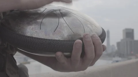 Hands play on hapi drum on waterfront closeup Video stock 89081883